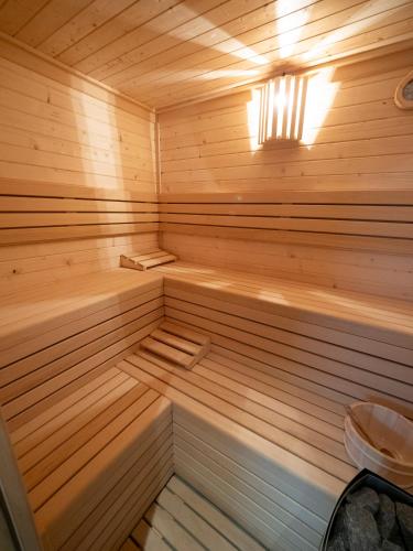 a small wooden sauna with a light on at Albergue Spa Cruceiro de Pedrouzo in O Pedrouzo