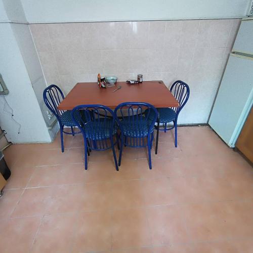 a wooden table and chairs in a room at Mary&George in Chişinău