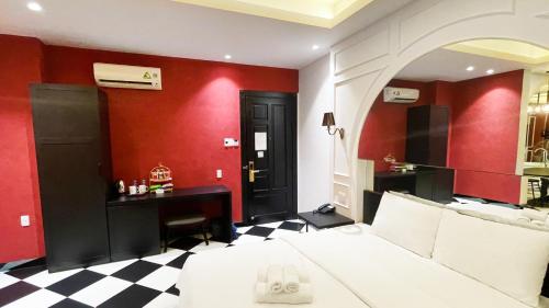 a bedroom with red walls and a checkered floor at A In Hotel Atistar in Ho Chi Minh City
