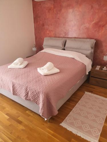 a bed with two white towels on top of it at Magdalena Cozy Apartment in Sparti