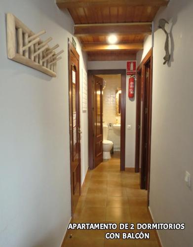 a hallway of a house with a toilet and a bathroom at Hostal Rural Sant Climent - Habitacions i Apartaments in Taull