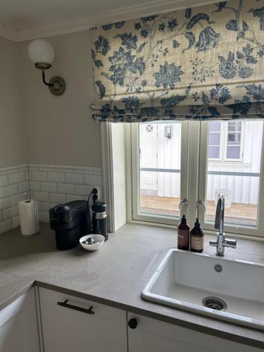 a kitchen with a sink and a window at Sjøgata Gjestehus No2 in Larvik