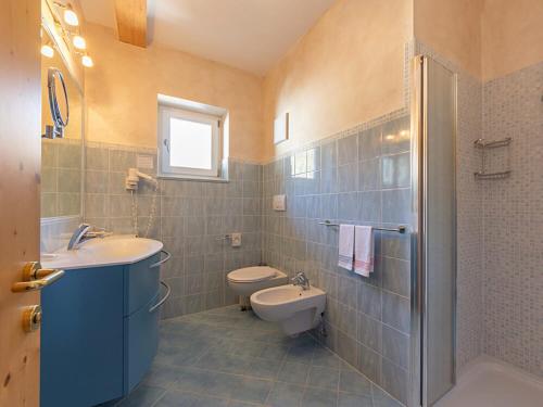 a bathroom with a sink and a toilet and a shower at Hotel Des Alpes in Soraga