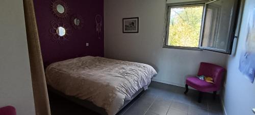 a bedroom with a bed and a window and a chair at Appartement katixa in Bayonne