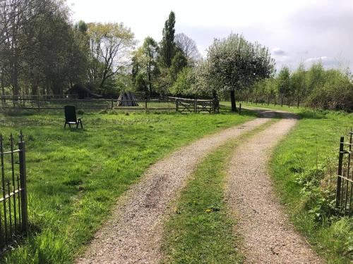 a dirt road in a field with a playground at de Zeilende kraay in Katwijk