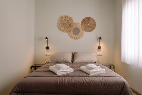 Ένα ή περισσότερα κρεβάτια σε δωμάτιο στο Joyma Boutique Apartments