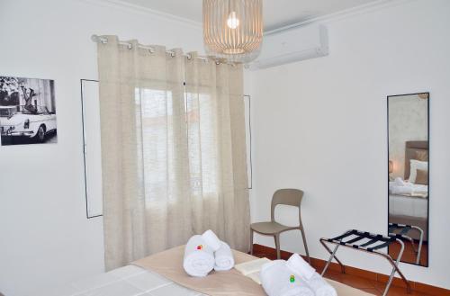 a bedroom with a bed with towels on it at Lux Downtown Reguengos in Reguengos de Monsaraz