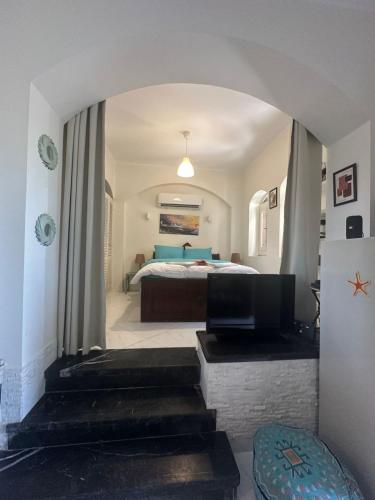 a bedroom with a bed and a room with a couch at chalet in nubian villas , behind Rihanna hotel in Hurghada