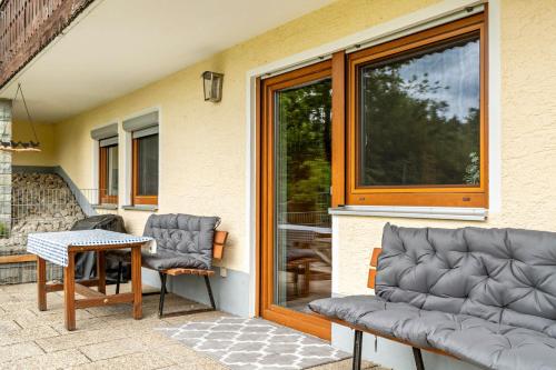 a pair of chairs and a table on a patio at Relaxinn Bavarian Fewo's in Wegscheid