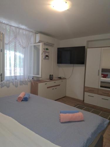 a bedroom with a bed with two pillows on it at Apartment Fortica in Senj