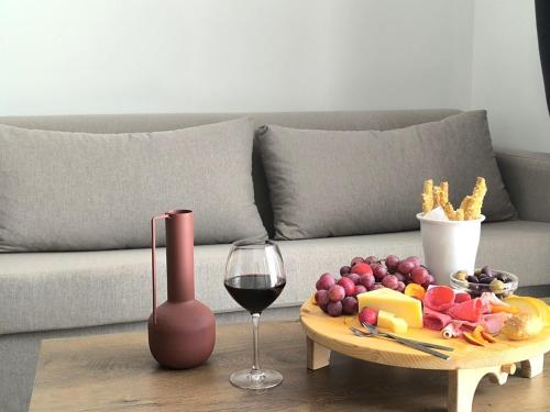 a table with a plate of food and a glass of wine at Valantina's & Mannouel Lardos Luxury Villas in Lardos