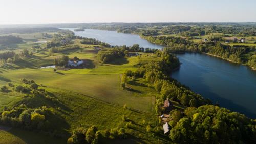 an aerial view of a house next to a river at Siedlisko Pod Strzechą in Wólka