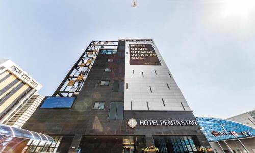 a tall building with a sign on it at Gimpo Pentastar Hotel in Gimpo
