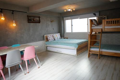 a bedroom with a bunk bed and a table and chairs at Residence Unicorn in Seoul