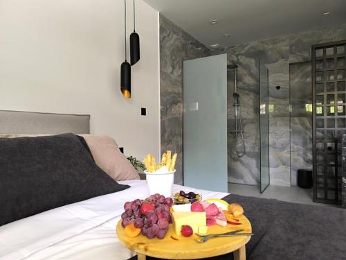 a tray of fruit on a table on a bed at Valantina's & Mannouel Lardos Luxury Villas in Lardos