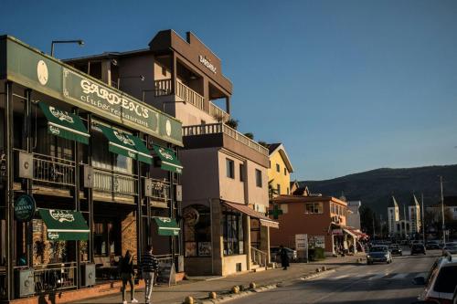 a group of buildings on a city street with cars at Hotel Holy in Međugorje