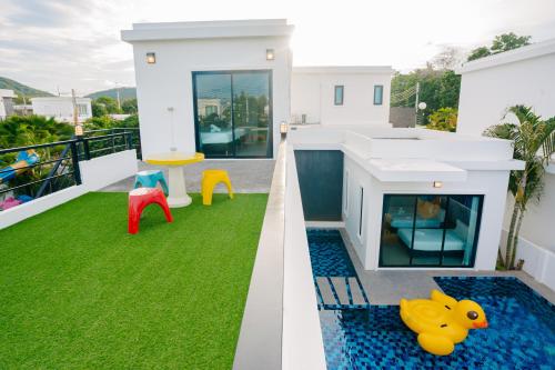 a house with a swimming pool on the balcony at Modern Life Pool Villa in Hua Hin
