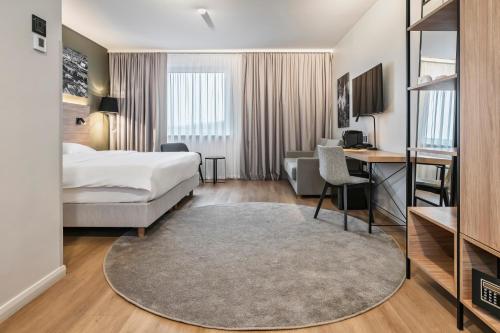a hotel room with a bed and a desk at Park Inn by Radisson Vilnius Airport Hotel & Conference Centre in Vilnius