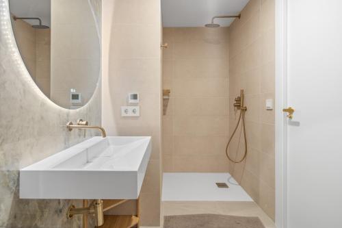 a bathroom with a white sink and a mirror at Secret View Riviera Del Sol in Sitio de Calahonda