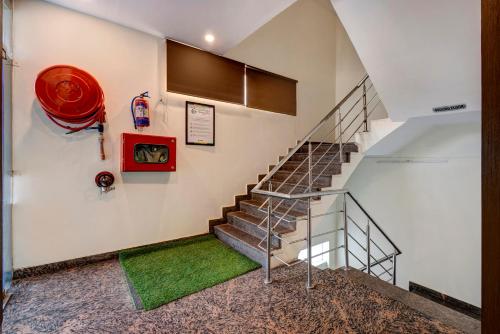 a staircase in a house with a green rug at Treebo Riddhi Paradise - 15 mins from Airport in Lucknow