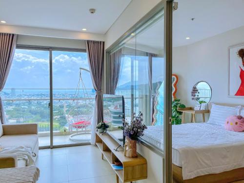 a bedroom with a bed and a large window at Gạo's Homestay - The Song in Vung Tau