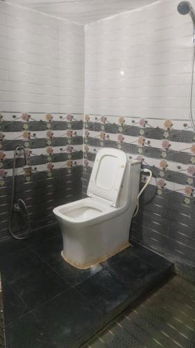 a bathroom with a toilet with the lid up at HOTEL SANA ! - A Best Budget Guest House And Banquet Hall In Lucknow in Lucknow