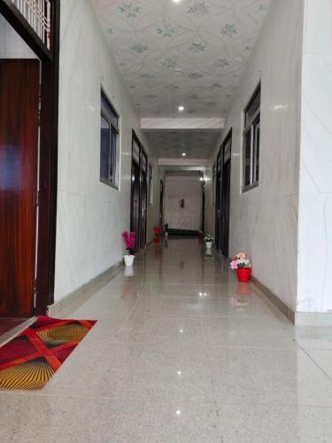 a hallway of a building with flowers in a corridor at HOTEL SANA ! - A Best Budget Guest House And Banquet Hall In Lucknow in Lucknow
