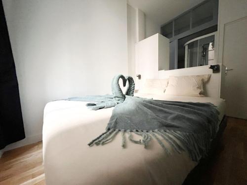 une chambre avec un lit avec un cygne dessus dans l'établissement L'Haussmanien, à Nantes