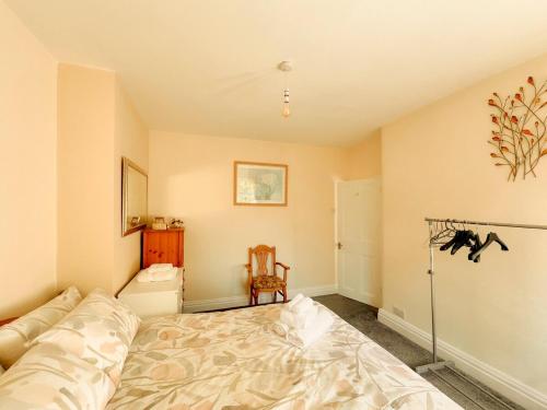 a bedroom with a bed and a chair in it at 3 Bedroom House by Brookland Stays Serviced Accommodation Short Lets Leeds in Yeadon