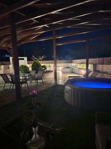 a patio with a pool and a table and chairs at Kazantzaki Residence in Archanes