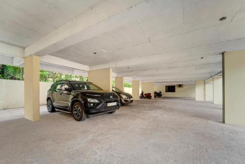 a garage with two cars parked in it at Treebo Pratham Inn, Manipal in Udupi
