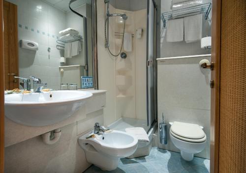 a bathroom with a sink and a toilet and a shower at Ecoresort Le Sirene - Caroli Hotels in Gallipoli
