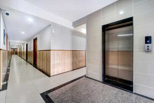 a hallway of a building with a door at Treebo Pratham Inn, Manipal in Udupi