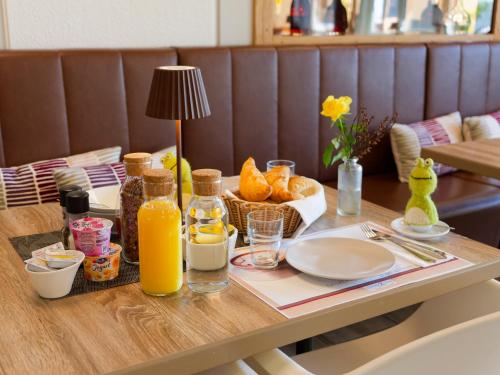 a table with a tray of food and orange juice at Seehotel Riviera at Lake Lucerne in Gersau