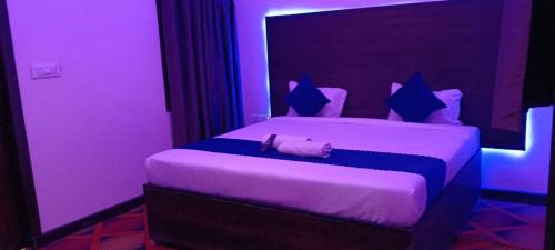 a purple room with a bed with a purse on it at HOTEL SANA ! - A Best Budget Guest House And Banquet Hall In Lucknow in Lucknow