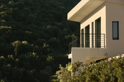 a building with a view of a mountain at Scirocco Luxury Villas & Suites in Vasiliki