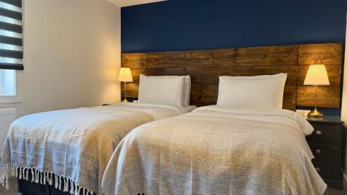 two beds sitting next to each other in a bedroom at Watermead House in Chard