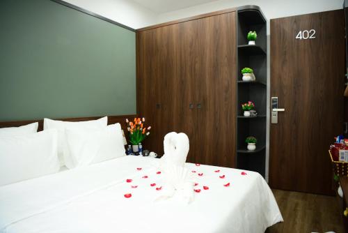 a bed with a white bunny sitting on top of it at Ocean Park Homestay in HÆ°ng YÃªn