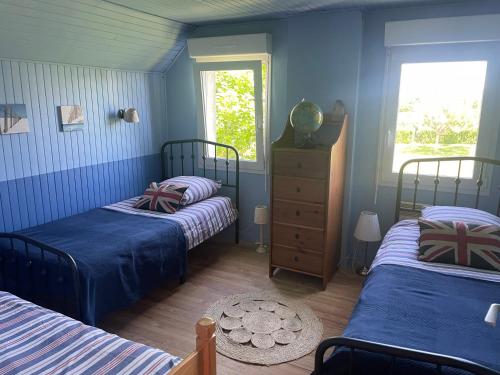 two beds in a room with blue walls at " Goarem Bihan" Villa de Charme Front de Mer in Plouarzel