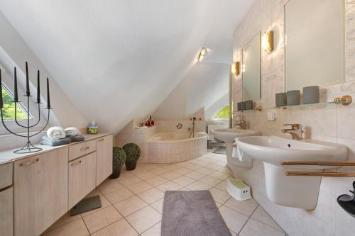 a bathroom with a sink and a tub and a toilet at Ferienhaus im Grünen in Harsefeld