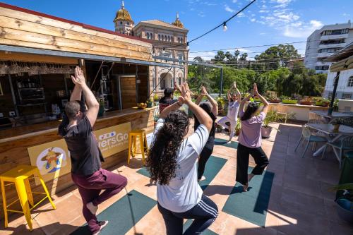 a group of people doing a yoga pose on a patio at GrowersGo Boutique Huelva in Huelva