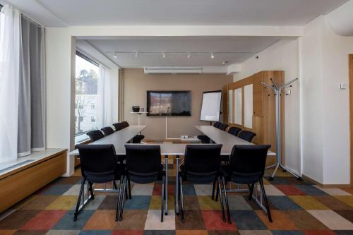 a conference room with a long table and chairs at Scandic Alvik in Stockholm