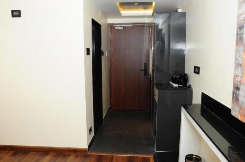 a hallway with a door leading into a room at Vgrand in Ooty