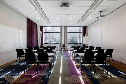 a conference room with chairs and a large window at Scandic Alvik in Stockholm