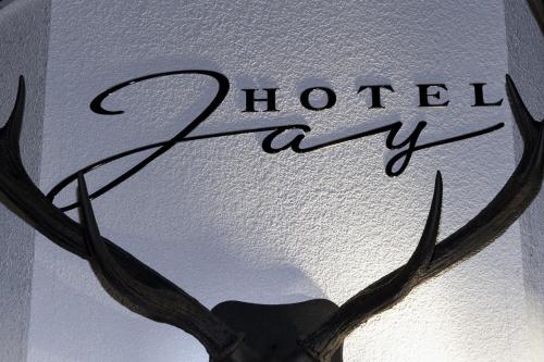 a sign with antlers on a wall with the word hotelasy at Hotel Jay -Adult Only- in Osaka
