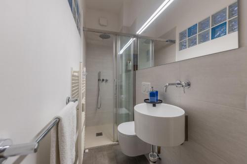 a white bathroom with a sink and a shower at Blue Dream in Ispra