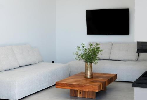 a living room with a couch and a coffee table at Scirocco Luxury Villas & Suites in Vasiliki