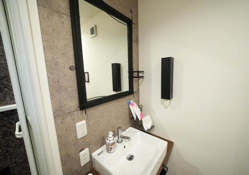 a bathroom with a sink and a mirror at RGH ISHIUCHI BASE02 - Vacation STAY 14828 in Hiroshima