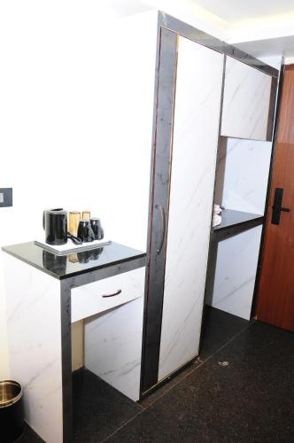 a kitchen with a glass door and a counter at Vgrand in Ooty