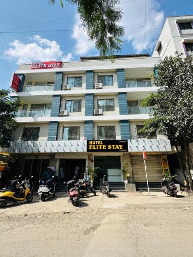 a group of motorcycles parked in front of a building at Hotel Elite Stay - Ashoka Nagar, Kharadi, Pune in Pune